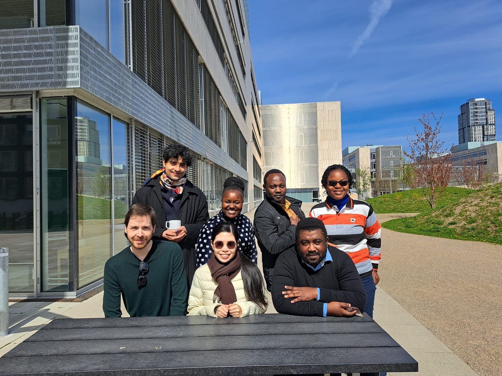 Research collaborators gathered outside an academic building