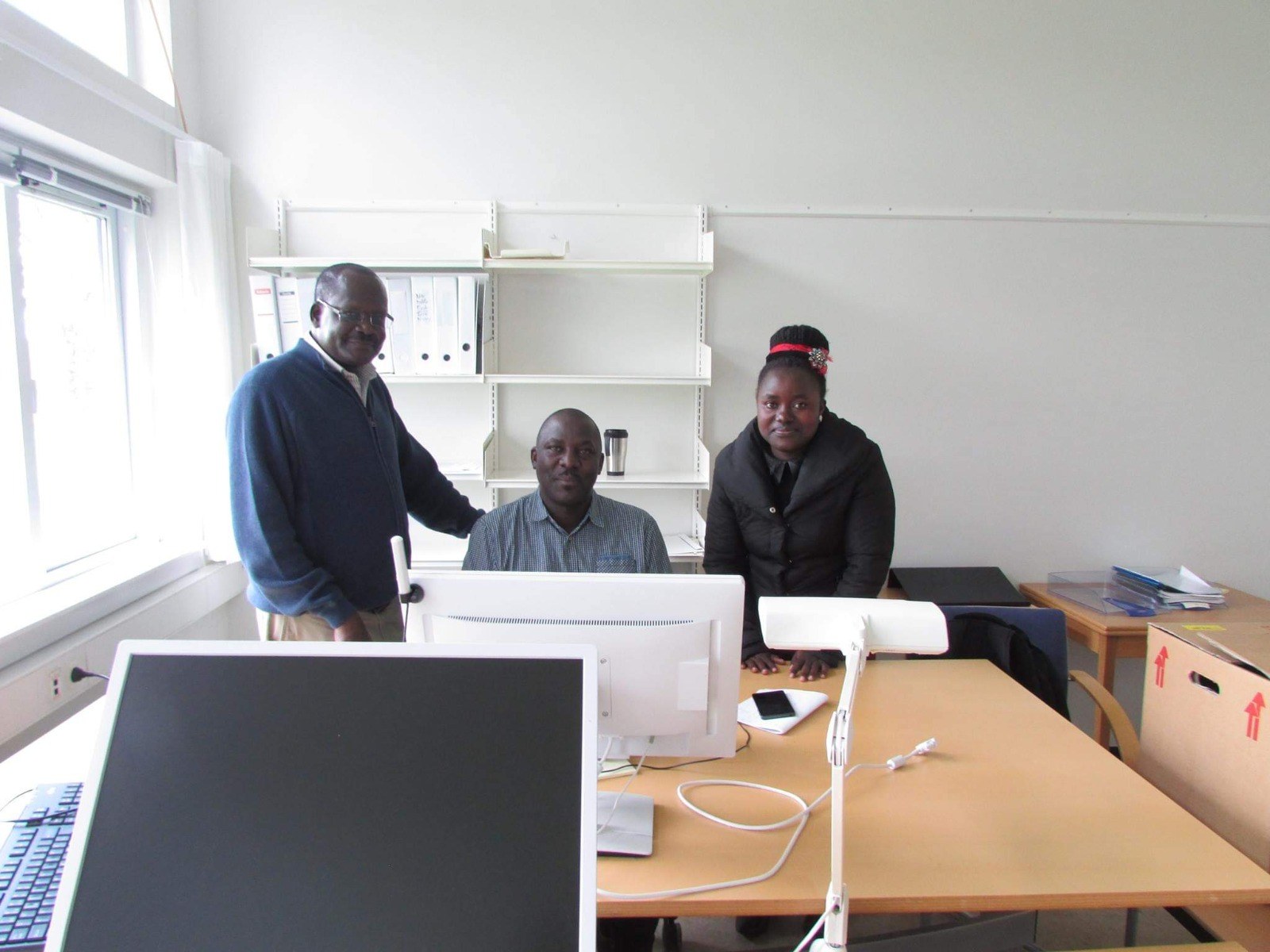 Research collaborators meeting in an office setting